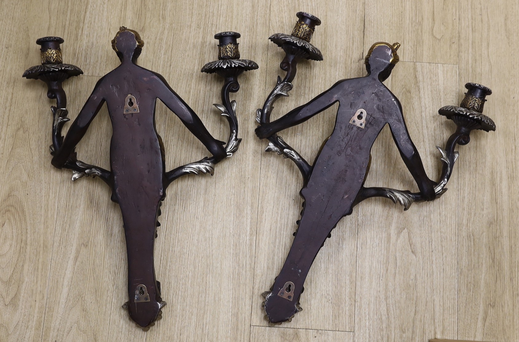 A pair of Blackamoor two branch wall lights, 53cm tall